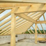Wooden trusses structure in an unfinished building highlighting construction progress.